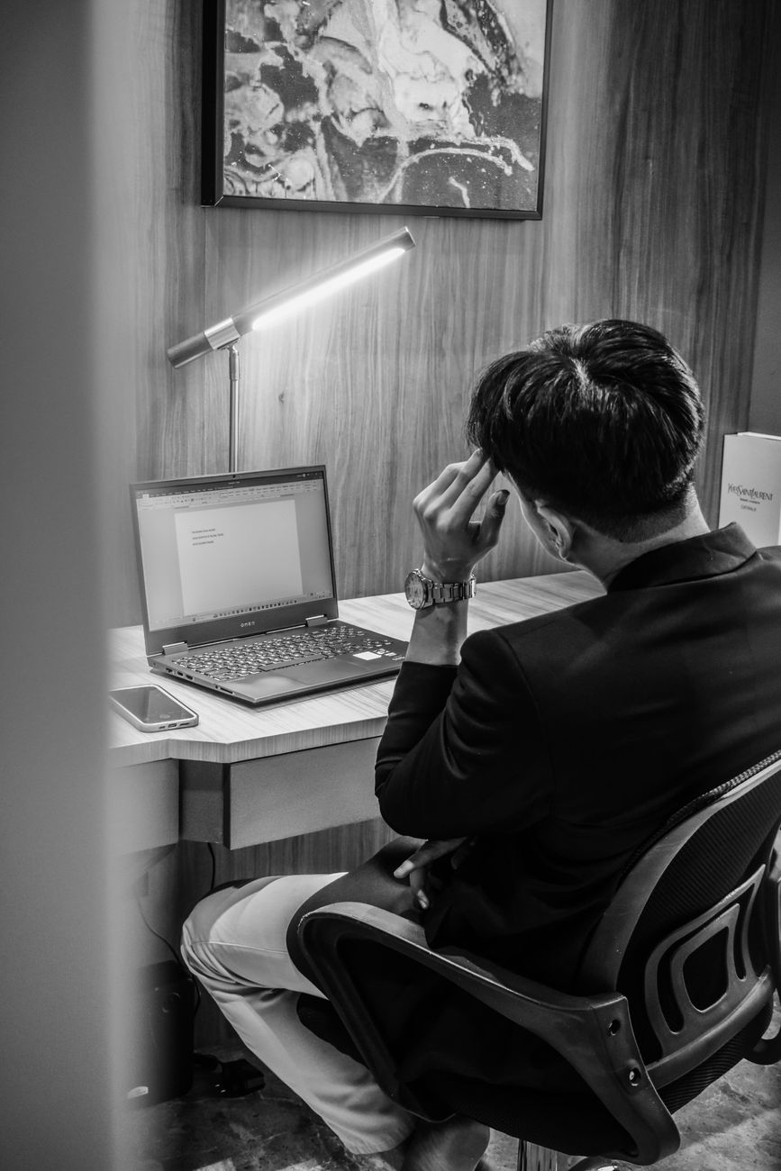 A businessman working late into the night at his office desk in Jakarta, Indonesia.
